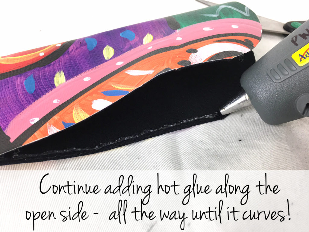 Step 9: Using the hot glue gun, apply a thin line of glue to the edges