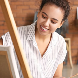 woman painting at easel